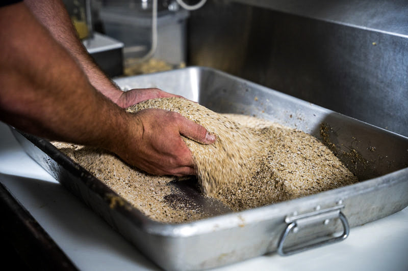 Hand sifting bacon seasoning Black Sheep Bacon